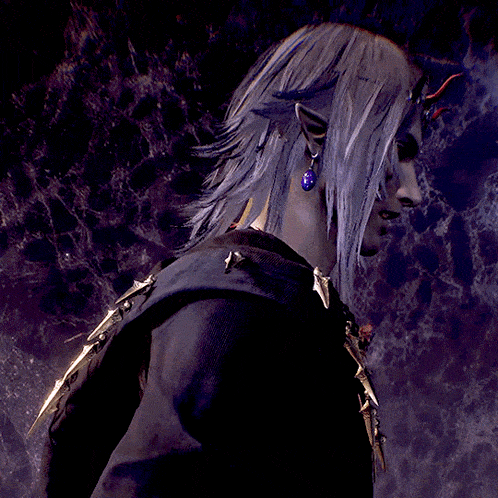 a man with horns on his head is wearing a black shirt and a necklace