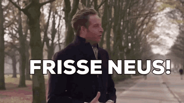 a man in a black coat is standing on a sidewalk with the words frisse neus written above him