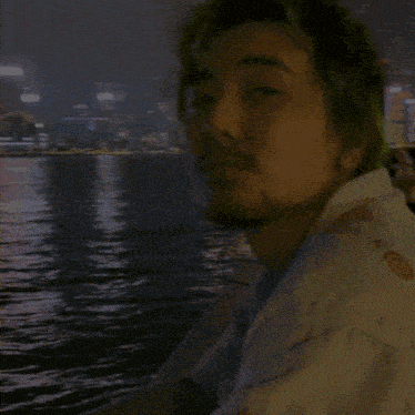 a man with green hair looks at the camera