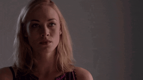 a close up of a blonde woman 's face with her mouth open