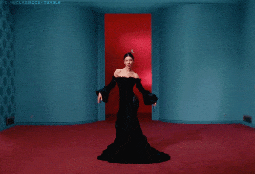 a woman in a black dress is standing in front of a red door that says clubclassics tumblr