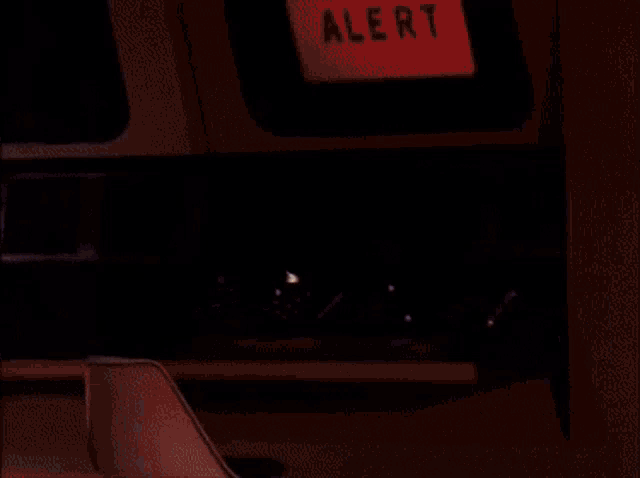 a desk with a few buttons on it and a light coming out of it