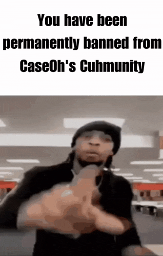a man in a black hat is pointing a gun at the camera .