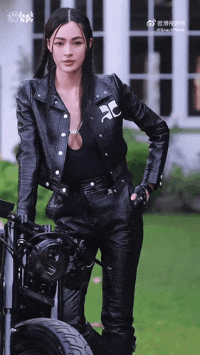 a woman in a leather jacket with the letter c on the front