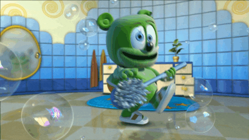 a green gummy bear is holding a toilet brush
