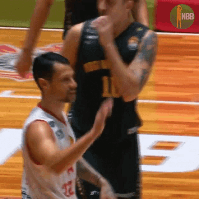 a basketball player wearing a number 10 jersey stands on the court