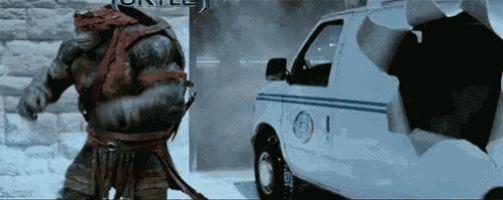 a teenage mutant ninja turtle is standing next to a white van with the word turtle on it