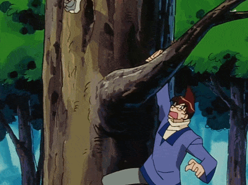 a man in a purple shirt is standing next to a tree