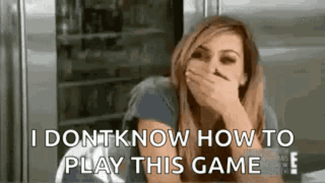 a woman is covering her mouth with her hand while playing a game .