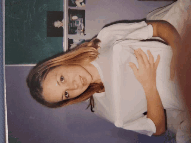 a woman in a white shirt is laying on her back
