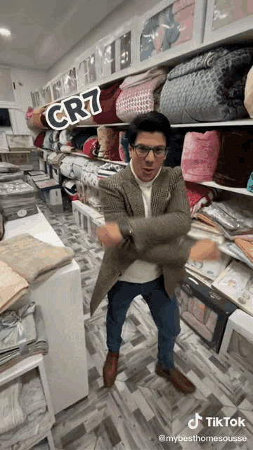 a man dancing in a store with a cr7 sticker