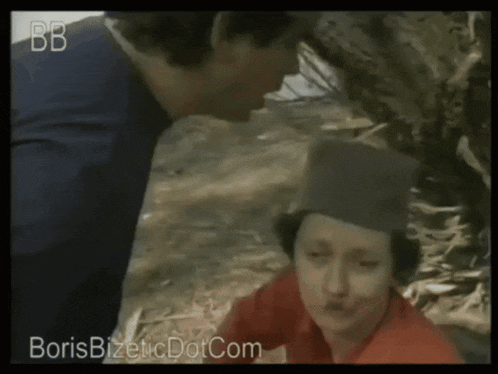 a man kisses another man on the cheek in a video that says boris bizetic dotcom