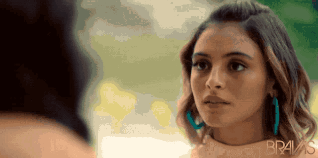 a close up of a woman 's face with the word bravas on the bottom