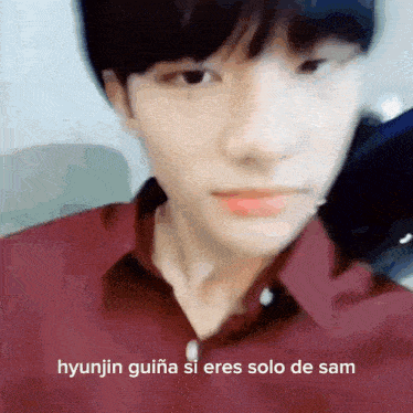 a close up of a person 's face with the words hyunjin guiana si eres solo de sam in the corner