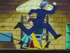 a man in a blue suit is jumping over a yellow chair
