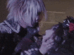 a man and a woman are standing next to each other and kissing .