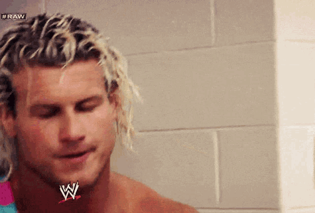 a close up of a man 's face with a wwe logo on his neck