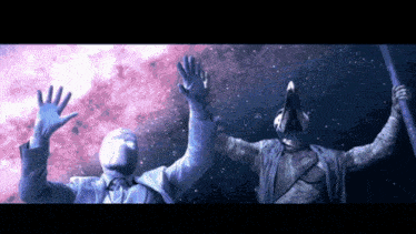 a statue of a man and a statue of a bird with their arms outstretched