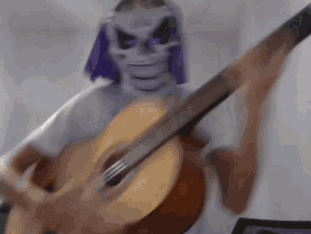 a person with a skeleton mask on playing a guitar