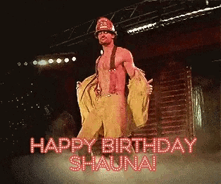 a man in a fireman costume is dancing on a stage with the words happy birthday shaunai behind him
