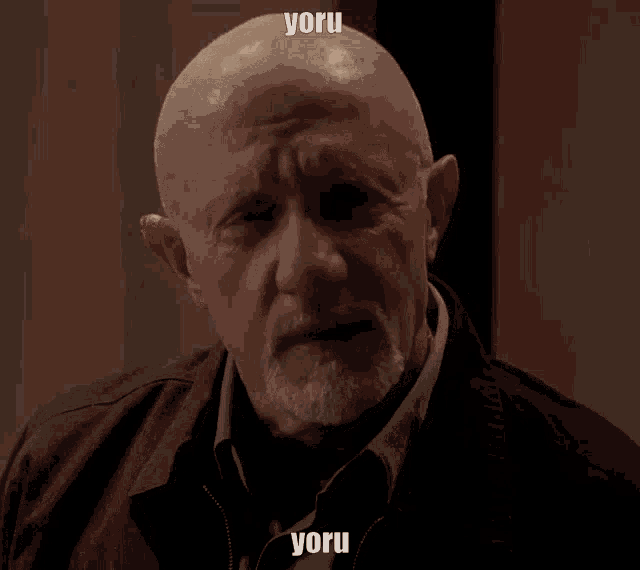 a bald man with a beard has the word yoru written on his forehead