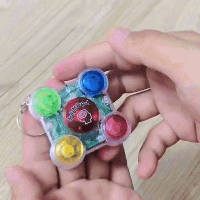 a person is holding a keychain that says ' memo ' on it