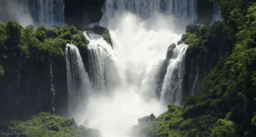 a waterfall is surrounded by trees and a headline that says headlinesmashing