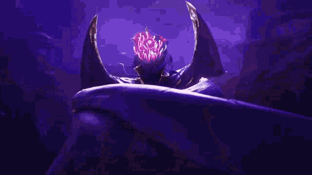 a shark is swimming in a dark aquarium with purple light coming out of its mouth .