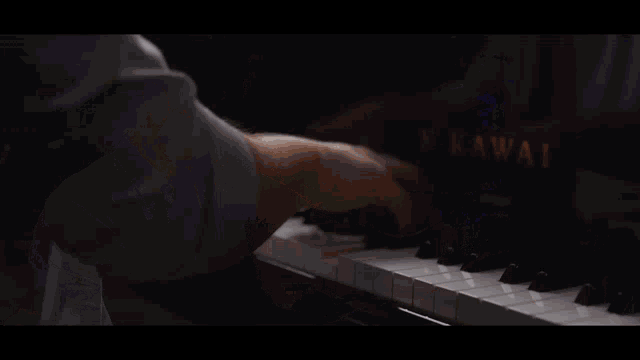 a man singing into a microphone while playing piano