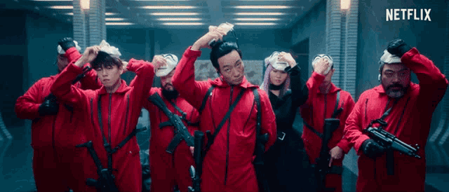 a group of people in red jumpsuits with guns and a netflix logo in the corner