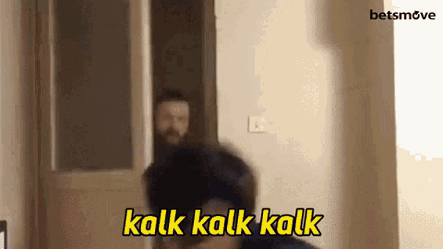 a man with a beard is standing in front of a door and the words kalk kalk kalk are above him