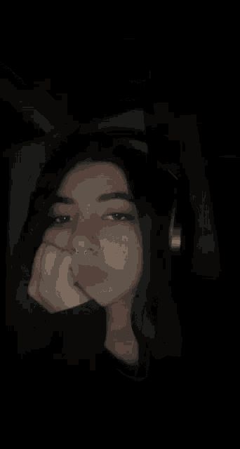 the girl is wearing headphones and has a nose ring