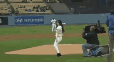 a baseball game is being played in a stadium with a dodgers sign in the outfield