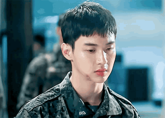 a young man wearing a military uniform has a patch on his chest that says ' yjb '