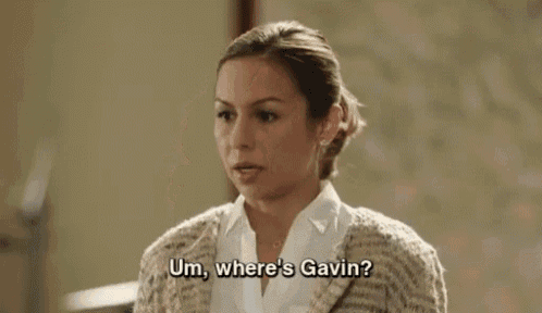 a woman in a sweater is talking to another woman and asking where gavin is .