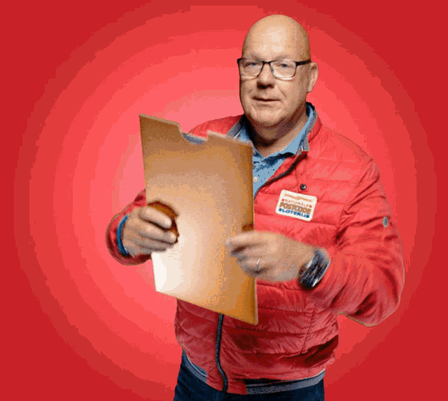 a man in a red jacket holds a clipboard and has a name tag that says ' postman ' on it