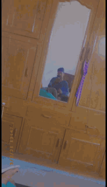 a blurry picture of a man taking a picture of himself in a mirror with the date of 7/21/21