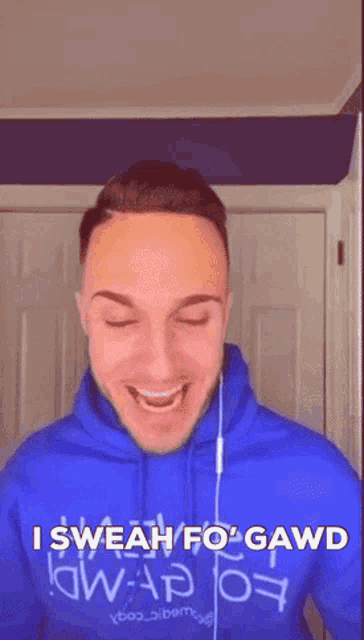 a man wearing a blue hoodie with the words i swear fo gawd written on it
