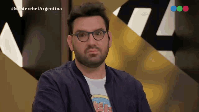 a man wearing glasses and a t-shirt that says ' the ' on it