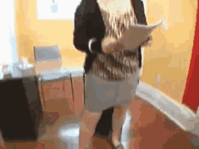 a woman is holding a piece of paper in her hand