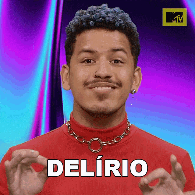a man wearing a red shirt and a chain around his neck has the word delirio on his chest
