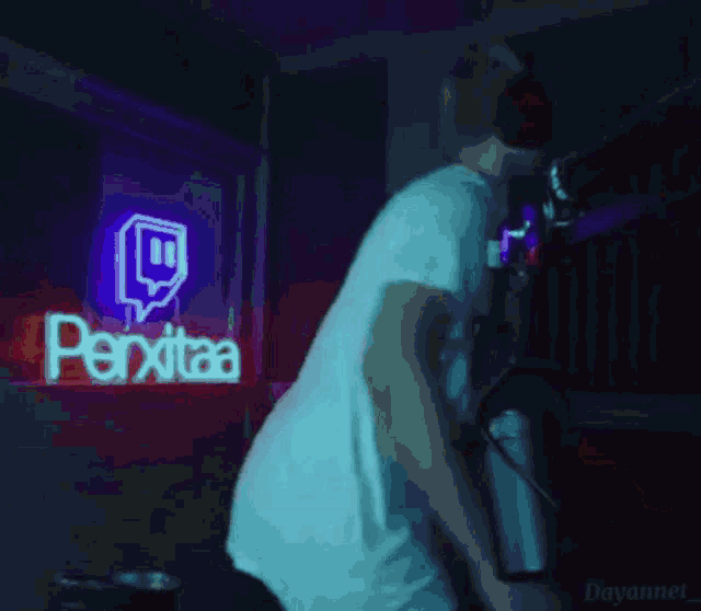 a man stands in front of a neon sign that says ' perxitaa '