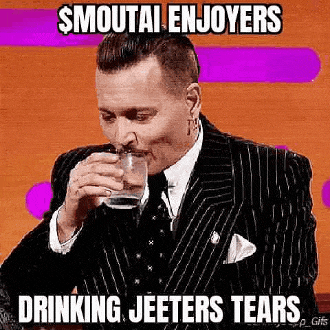 a man in a suit and tie is drinking a glass of water and making a funny face .