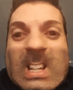 a close up of a man 's face with a beard