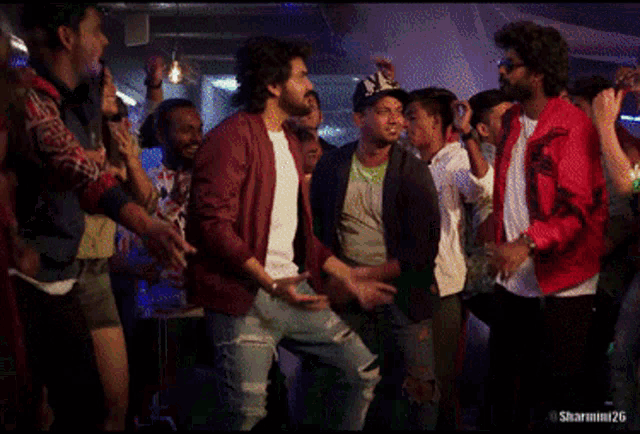 a group of people are dancing in a club with the hashtag sharmini26 at the bottom