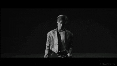 a black and white photo of a man in a leather jacket