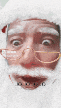 a close up of a santa claus face with the words jo jo jo jo written below it