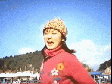 a woman wearing a leopard print hat and a red jacket with flowers on it