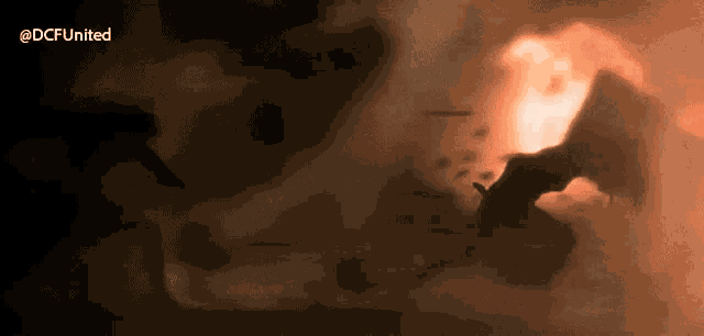 an animated image of a fire with the words @dcfunited written below it