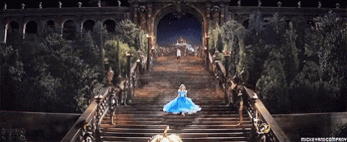 a woman in a blue dress is walking down stairs